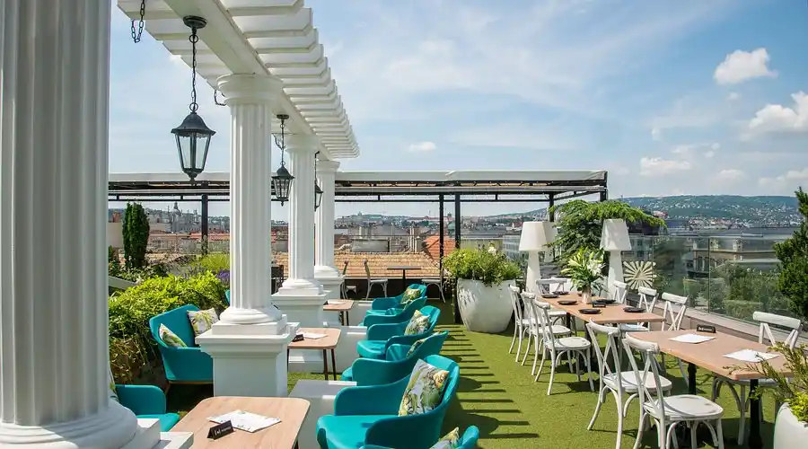 Rooftop terrace party with lights and DJ setup at night