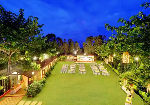 Luxury garden venue with tropical landscaping and open air stage setup