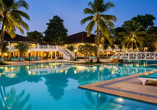 Beachfront resort with sunset wedding ceremony setup